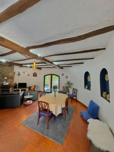 a living room with a table and chairs at O Moinho de Vale da Mó in Anadia