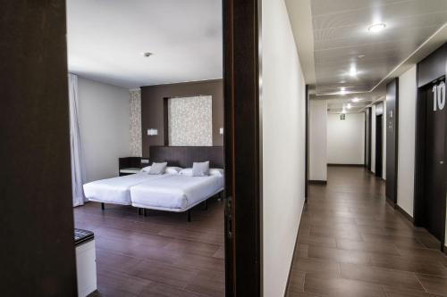 Postel nebo postele na pokoji v ubytování Hotel Alda Carril