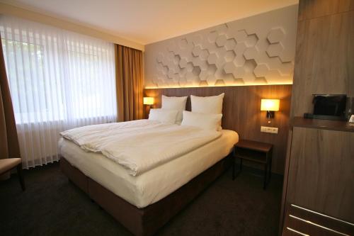 Postel nebo postele na pokoji v ubytování Hotel Graf Balduin
