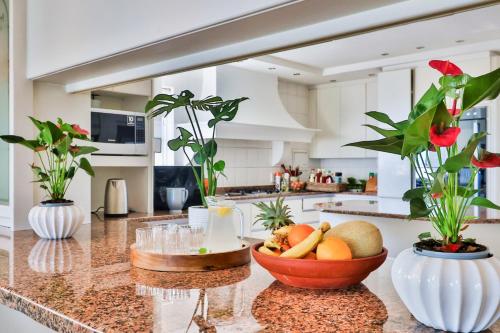 a kitchen with a bowl of fruit on a counter at Hermanus Beachfront Lodge - Solar Power in Hermanus