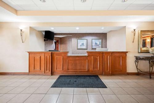 a large room with a kitchen with wooden cabinets at Best Western Annawan Inn in Annawan