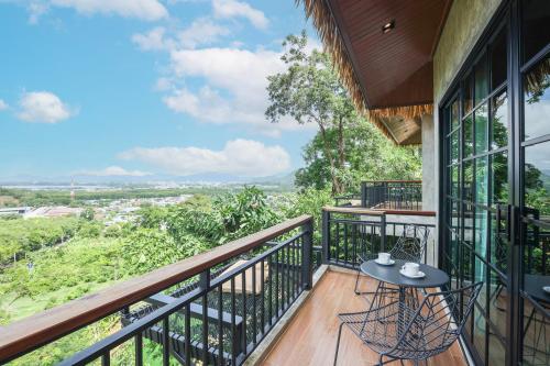 a balcony with a table and chairs and a view at Pha Lae Tawan@Siray in Ban Lo Ti Pa (1)