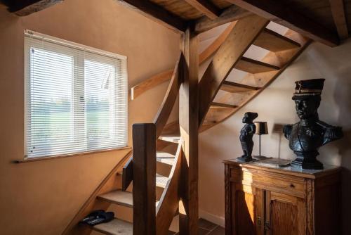 a room with a spiral staircase in a house at La fermette d'Hacquegnies in Hacquegnies