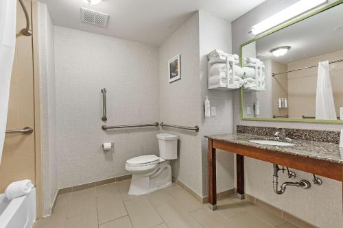 a bathroom with a toilet and a sink at Hampton Inn - Atmore in Atmore