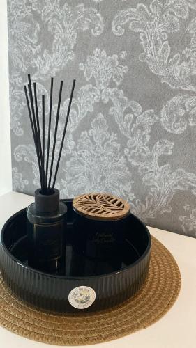 a black container with sticks in it on a table at Apartment Ariella in Jūrmala