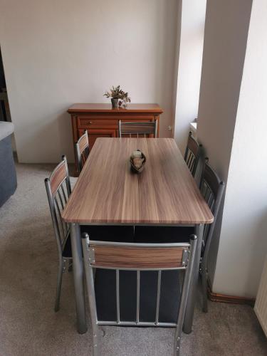 a wooden table with chairs in a room at Dům na hradbách in Žatec