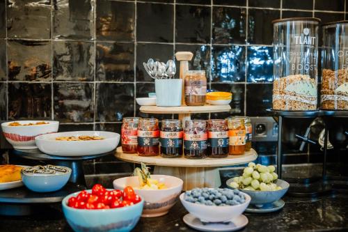 a display of food in bowls and jars on a counter at Boutique hotel Maison Emile in Antwerp