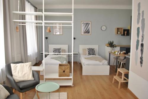 a living room with a bunk bed and a chair at 7nights Apartments Dominikánské naměstí in Brno