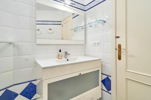 a white bathroom with a sink and a mirror at Primera línea con terraza A104 in Torrox