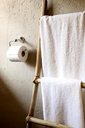 a towel rack with a roll of toilet paper on it at House of Perez in Wellington