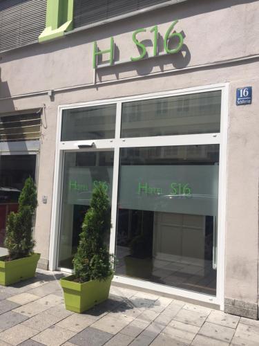 a store window with two plants in front of it at Hotel S16 in Munich
