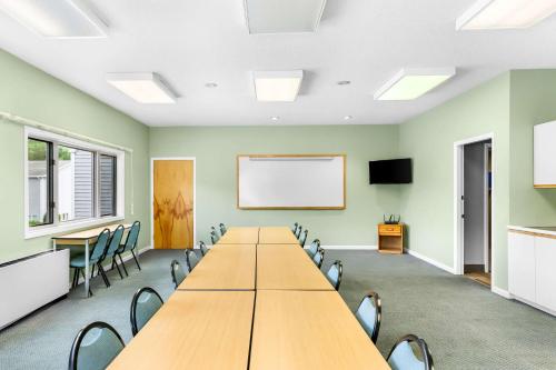 a conference room with a long table and chairs at Rodeway Inn Gorham Riverside in Gorham