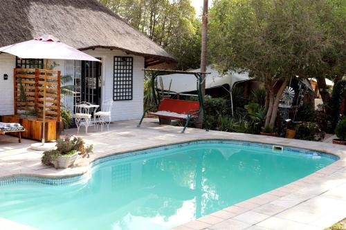 a swimming pool in front of a house at House of Perez in Wellington