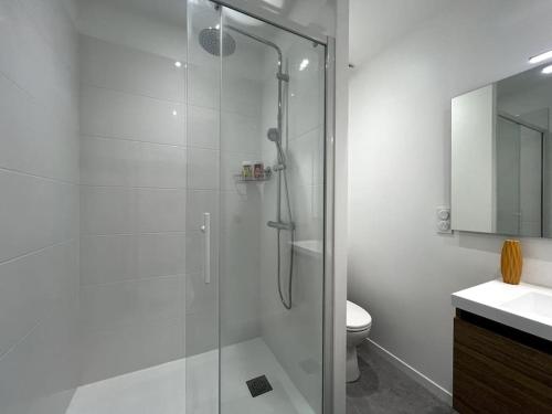 a bathroom with a glass shower and a toilet at Family house - Exterieur 4 pers - 3 beds in Fontainebleau