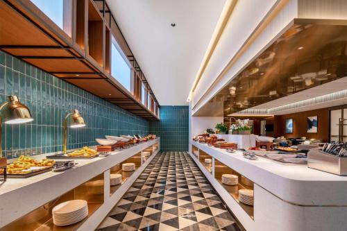 a restaurant with a checkered floor at Hilton Garden Inn Tianjin Railway Station in Tianjin