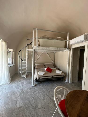 a bedroom with two bunk beds and a table at Palazzo del Vescovo in Gozzano