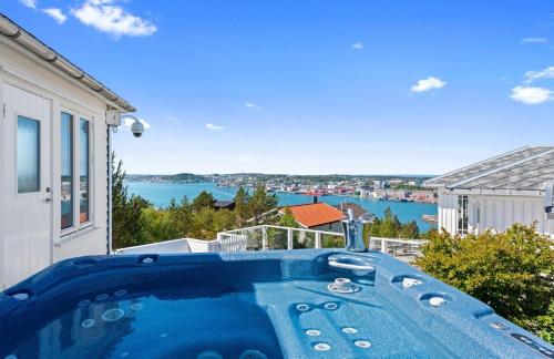 a hot tub on a balcony with a view of the water at Villa Freya with stunning sea view in Kristiansund