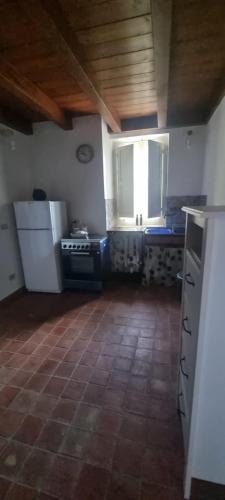 a kitchen with white appliances and a wooden ceiling at Maison Canopée in Messina