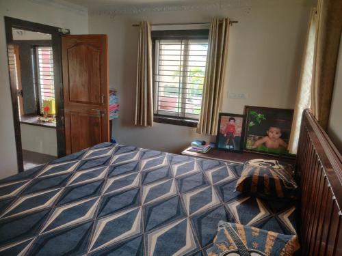 a bedroom with a large bed and a window at Siva Rama garden 5star stay , swimming pool,room nomber 3&4, , bheemili to dorathota in Visakhapatnam
