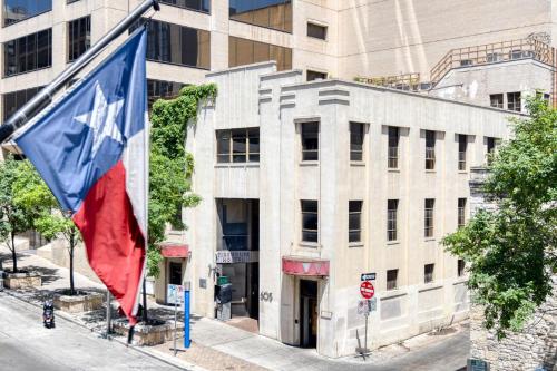 a flag is flying in front of a building at Firehouse Hostel in Austin