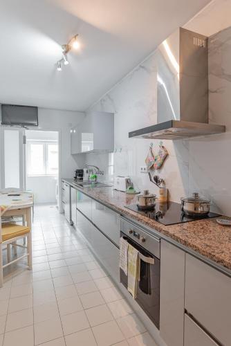 a kitchen with a counter top with pots and pans at Avenida: Central, Garage, Metro in Vila Nova de Gaia