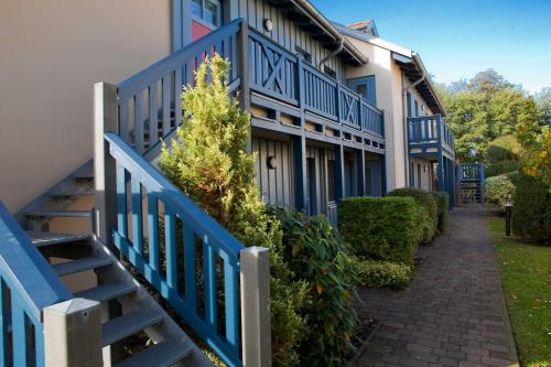 a blue fence next to a building with a staircase at Störtebeker 14 in Kühlungsborn