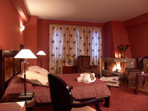 a bedroom with a bed and a fireplace in it at Aloni Toy Kir Thanasi Hotel & Spa in Volakas
