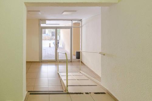 an empty room with a glass door and a staircase at Herzliya Pituach Apartment with Pool, by the Beach in Herzelia 
