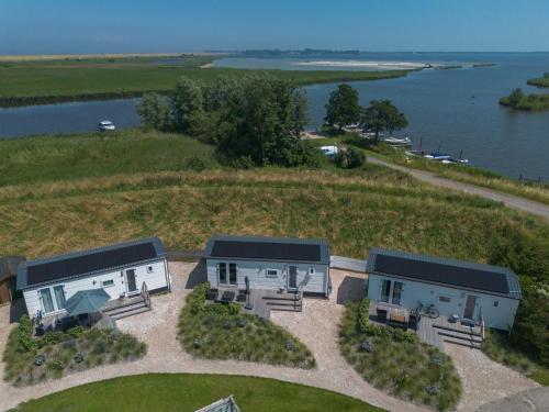 an aerial view of a house on a river at Camping Wad noch Meer in Anna Paulowna