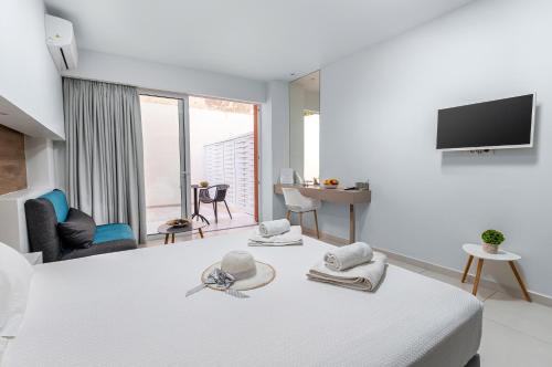 a hotel room with a bed and a tv at Notus Chania Crete in Chania Town