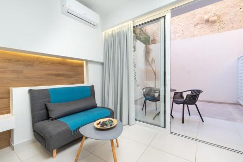 a living room with a couch and a table at Notus Chania Crete in Chania Town