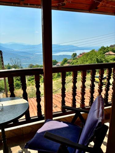a balcony with a chair and a table and a view at Iaspis Guesthouse in Kastoria