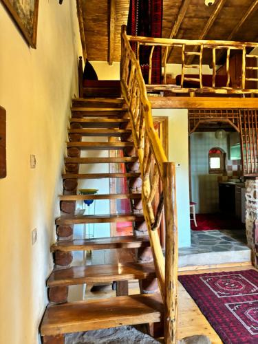 a wooden stairway in a house with a wooden ceiling at Iaspis Guesthouse in Kastoria