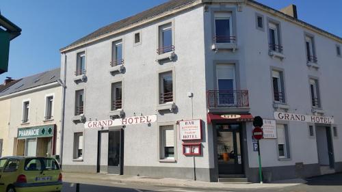 a large white building on the corner of a street at Grand Hôtel in Saint-Père-en-Retz