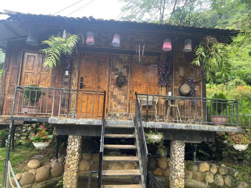 a wooden house with stairs leading to it at Sapa Bamboo Eco in Sa Pa