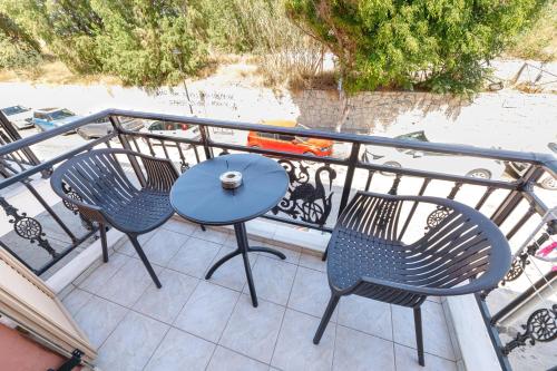 a patio with two chairs and a table on a balcony at Notus Chania Crete in Chania Town