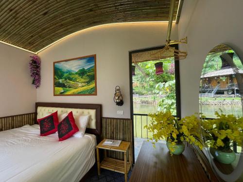a bedroom with a bed and a window at Sapa Bamboo Eco in Sa Pa