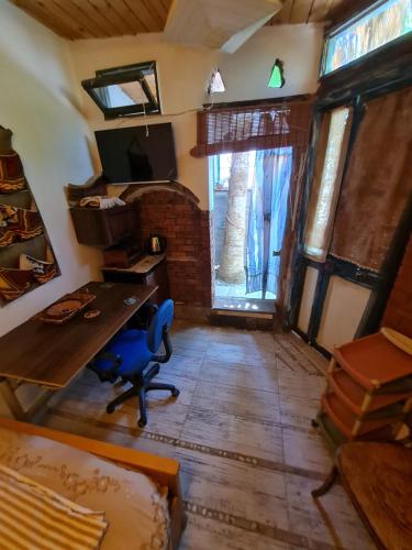 an office with a desk and a table in a room at Andyvone at yvone in Dahab