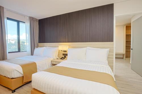 Postel nebo postele na pokoji v ubytování Hamersons Hotel CDO