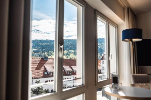 a room with a window with a view of a building at Seehotel am Kaiserstrand in Lochau