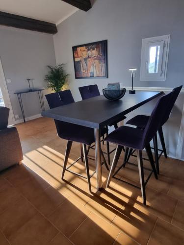 une table à manger et des chaises dans un salon dans l'établissement La Mélenzanice, à Castagniers