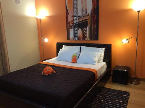a bedroom with a bed with two stuffed animals on it at Villa dos Teixos in Cascais