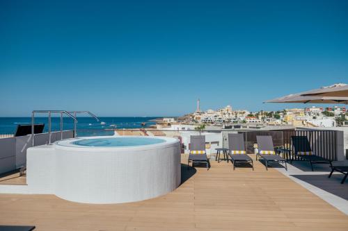 a hot tub on the roof of a building at Hotel Cetina Cabo de Palos Puerto in Cabo de Palos