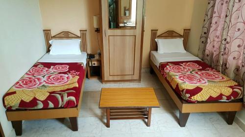 two beds sitting next to each other in a room at Hotel The Citadel in Vasco Da Gama