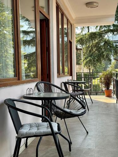 a group of chairs and tables on a porch at Central Kvareli in Kvareli