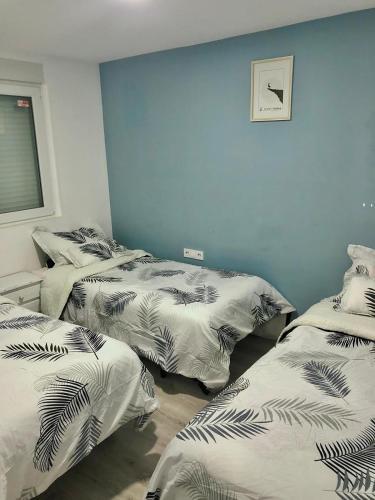 three beds are lined up in a room at Vila Peña Private Apartment with Shared Pool & Gardens in Cubelles
