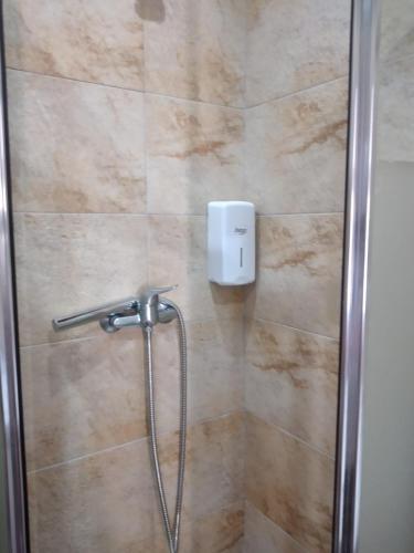 a bathroom with a shower with a glass door at Casa das Laranjeiras in Pinhão