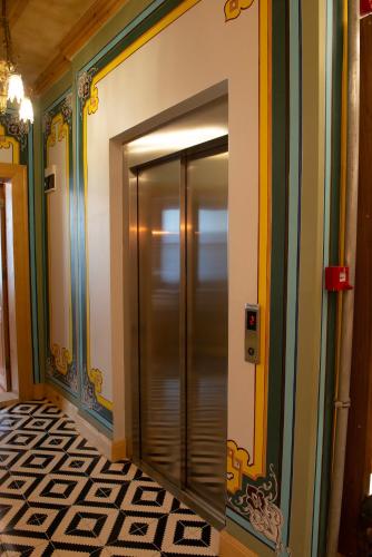 a elevator in a hallway with colorful walls at İstanbul Eagle's Nest Boutique Hotel in Istanbul