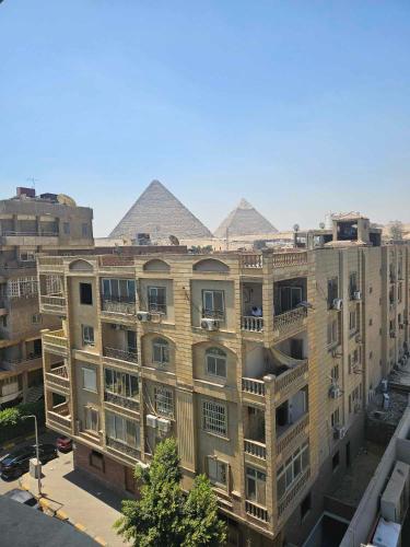 an apartment building with pyramids on top of it at The Home Boutique Hotel Pyramids Inn in Cairo
