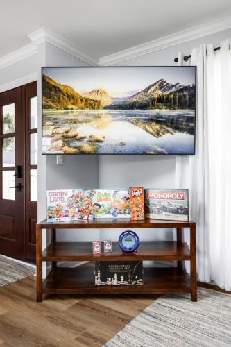 a living room with a television on a wall at Hometown Hideaway - 4br25ba, Pool, Game Room in Greenwood